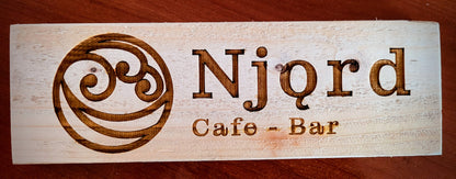 Close-up of engraved logo detail on wooden business sign – Moon Groves Devon UK
