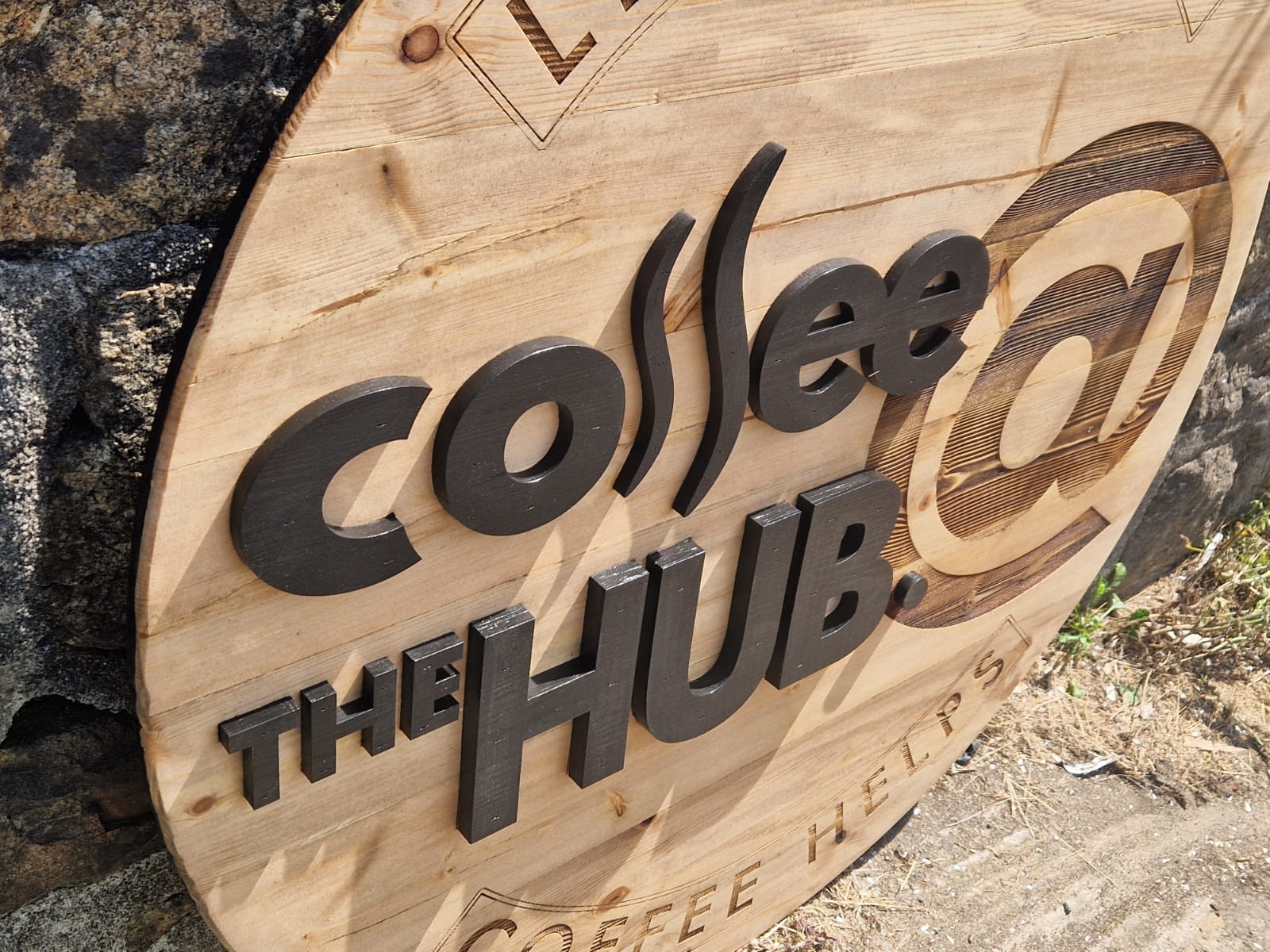 Close-up detail of raised 3D lettering on bespoke wooden commercial sign – hand-cut and painted, laser engraved Scandinavian Redwood